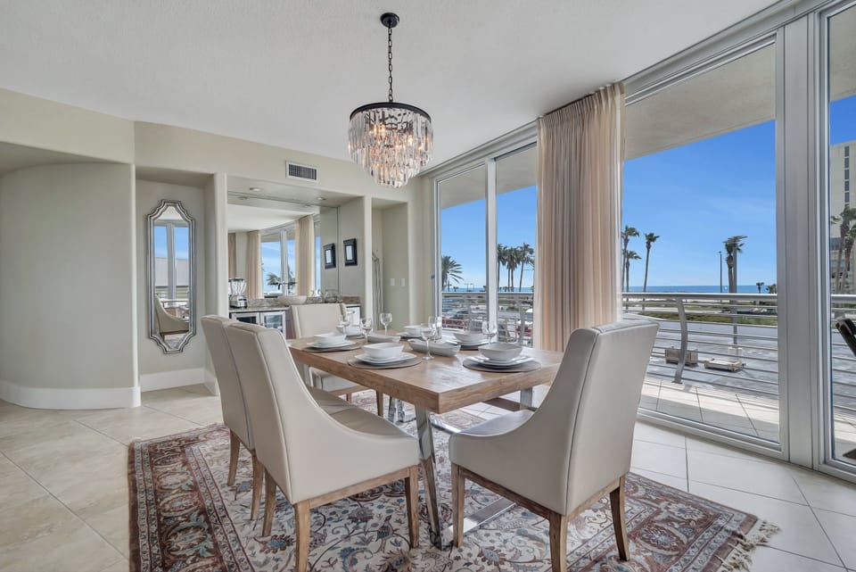 Gather around the elegant dining table, ready for memorable meals and conversations in this beautifully appointed bayfront condo.