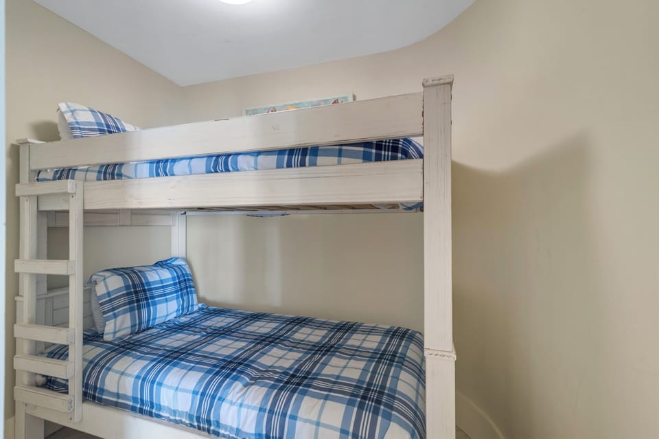Versatile bunk bed room offering comfortable accommodations for guests or family. This space maximizes functionality and style, providing a cozy and inviting atmosphere.