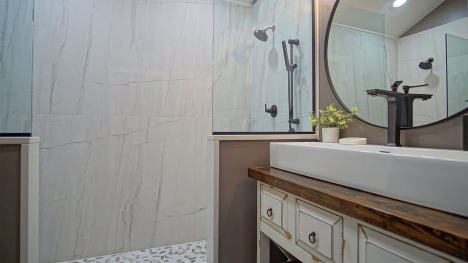 The 3rd floor master bathroom has a floor-to-ceiling tiled double stand-up shower.