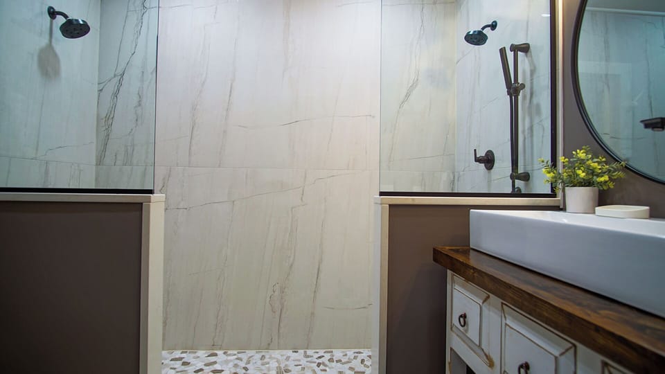 The 3rd floor master bathroom has a floor-to-ceiling tiled double stand-up shower.