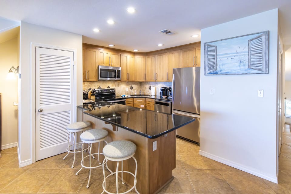 Kitchen with additional bar seating for 3.