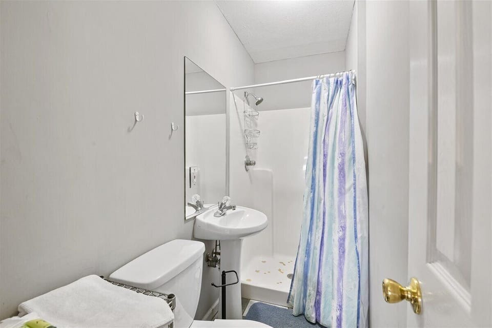 Bathroom with standing shower off bedroom with efficiency