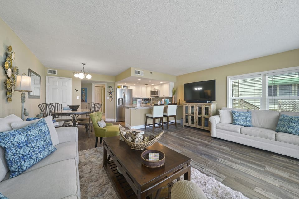 This airy, open concept living room offers direct balcony access with unobstructed ocean views.