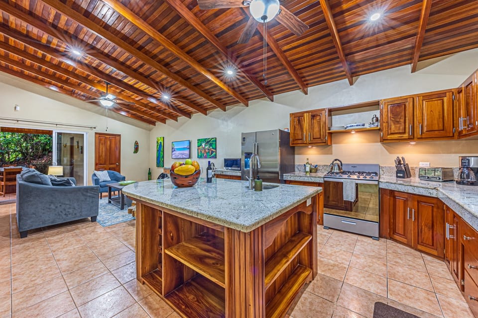 Fully equipped open kitchen with warm wood finishes and space to gather