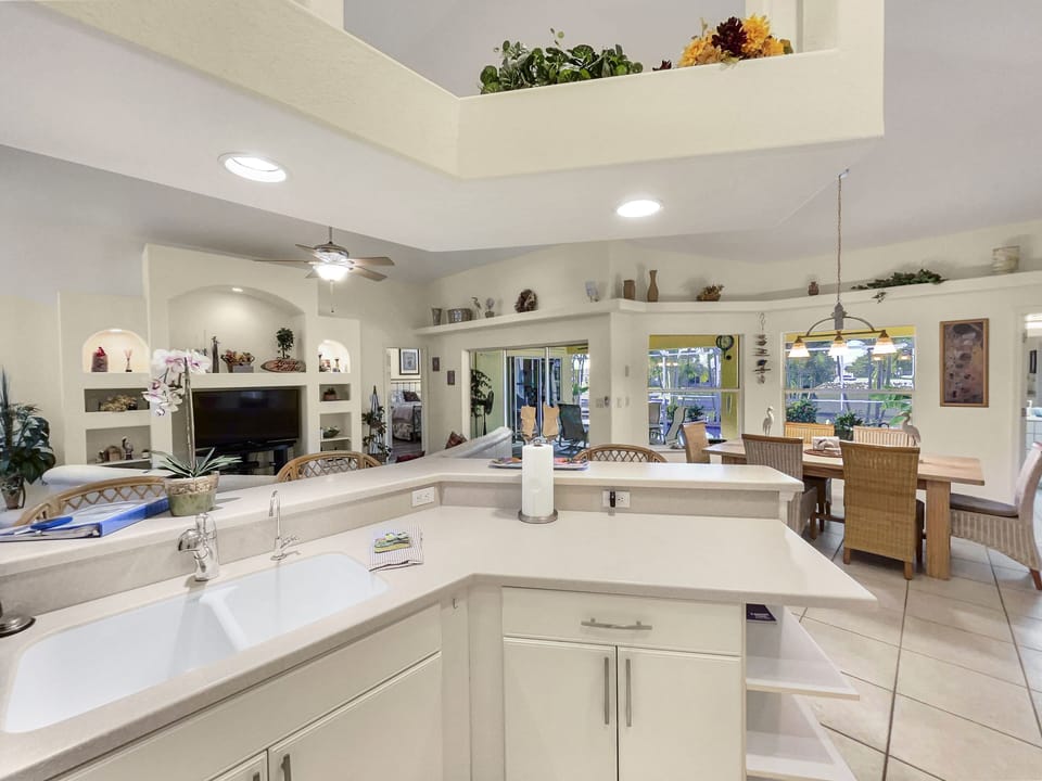 Kitchen with white cabinets, island counter, and open layout