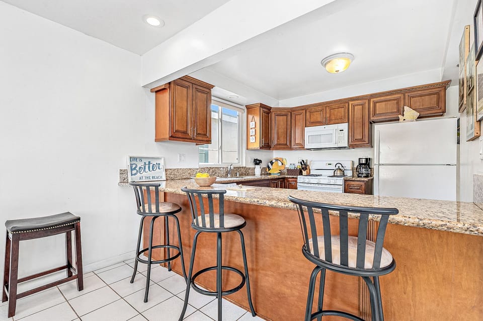 The kitchen counter includes barstool seating, making meal prep a social affair!
                