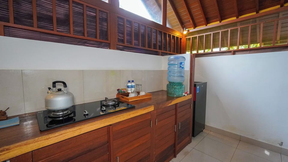 Deluxe Room with Balcony | Private kitchen | Fridge, electric kettle