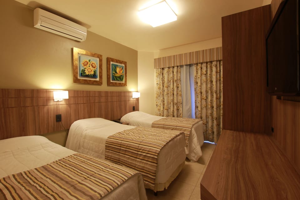 Deluxe Room | Minibar, blackout drapes, free cribs/infant beds, free WiFi