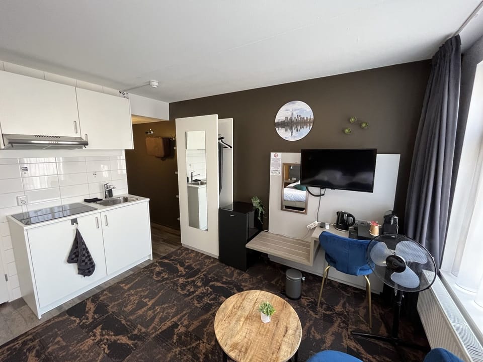 Desk, laptop workspace, blackout drapes, iron/ironing board