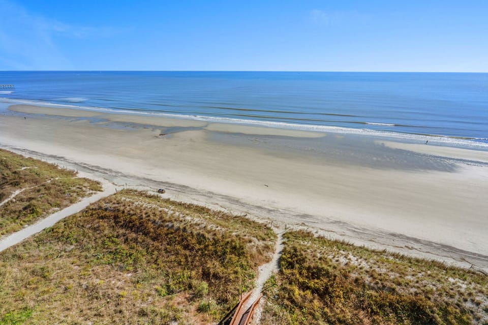 Sandy path through the dunes to the surf at Sunrise Pointe 11C, a 3-bedroom Cherry Grove beach rental