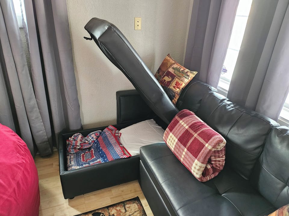sheets, blankets, and pillows for the sofa bed are found in the lounger
