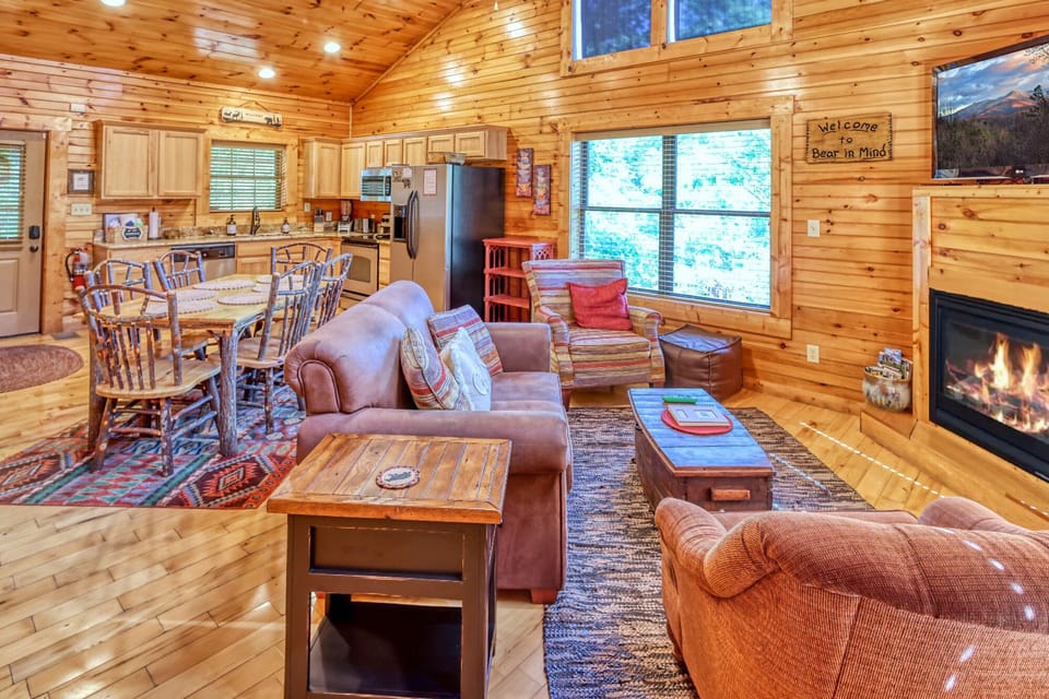 Open family room and kitchen with TV, fire place, and access to back deck.