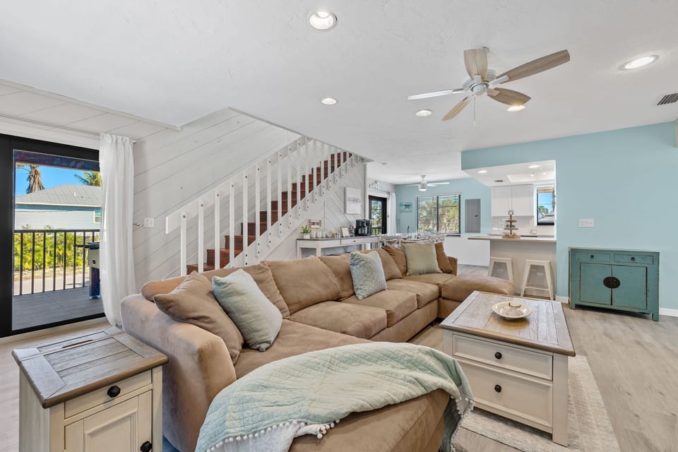 Spacious living area with open floor plan and large TV