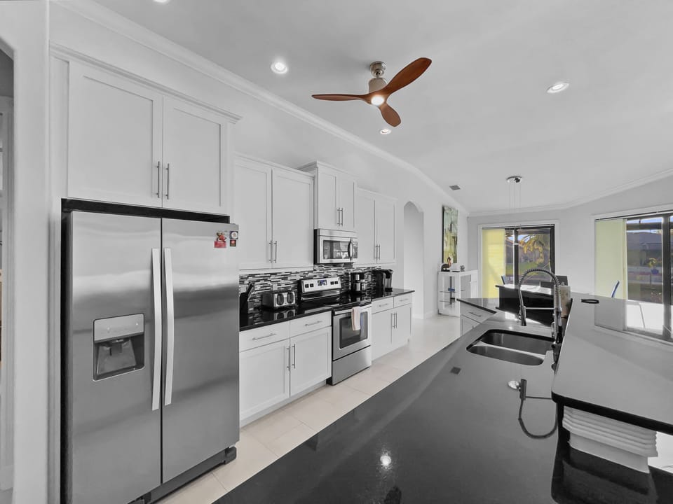 Kitchen featuring stainless steel appliances, granite counters, and ample cabinetry