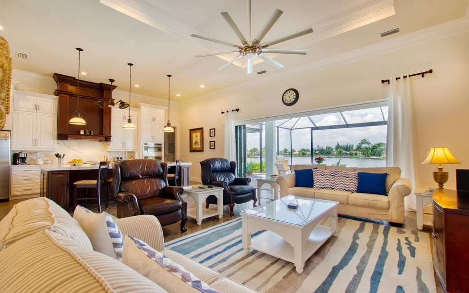Living room with leather chairs, sofa, and open floor plan