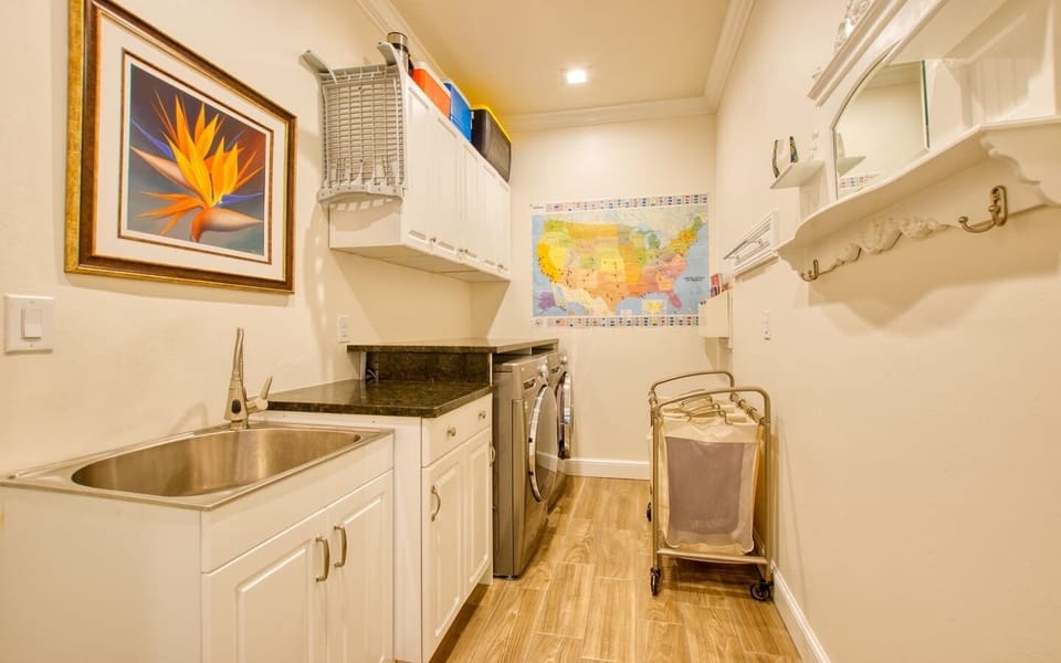 Laundry room with washer and dryer and utility sink