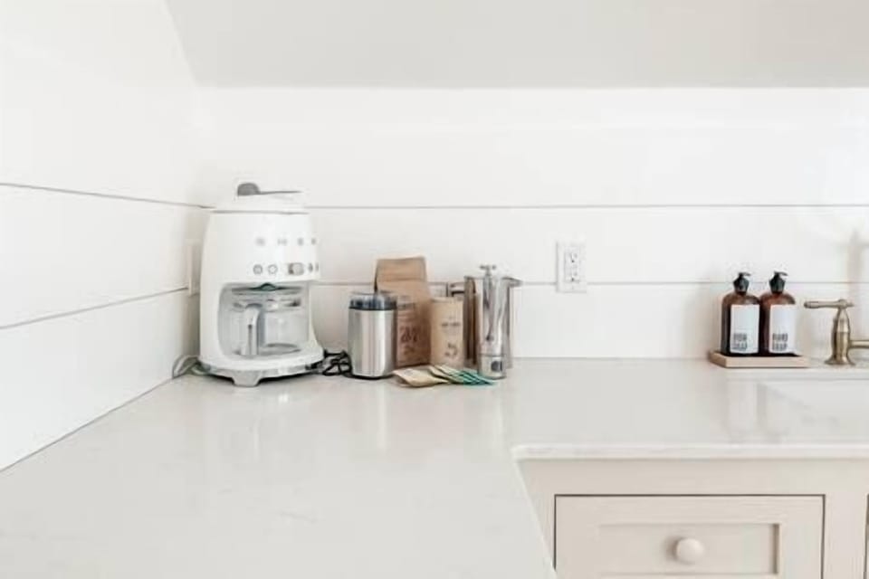 Coffee station with locally roasted coffee, French press, coffee maker, assorted teas and sugars.