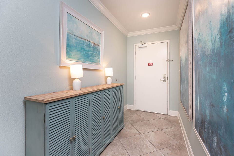 Step into a refreshing entryway, where calming art and soft lighting welcome you to unwind by the coast