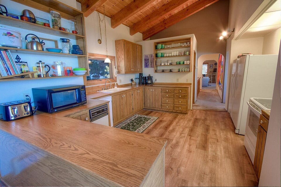 Kitchen featuring range, microwave, refrigerator, and dishwasher.