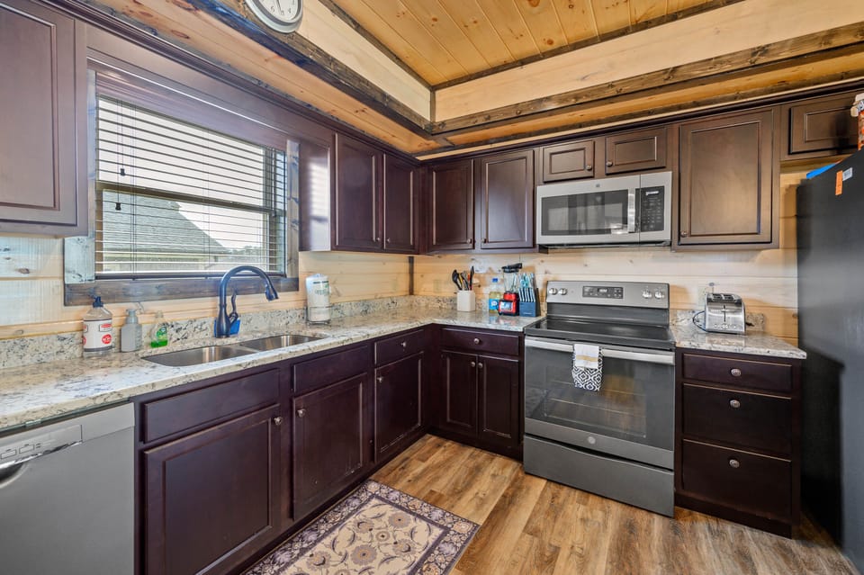 The fully stocked kitchen includes a coffee pot, toaster, microwave, and more. 