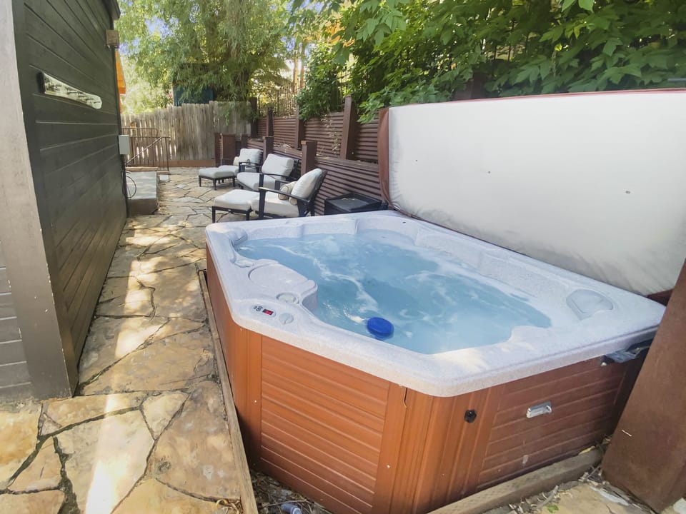 Private outdoor patio with a relaxing hot tub, perfect for unwinding under the stars after a day of Park City adventures.