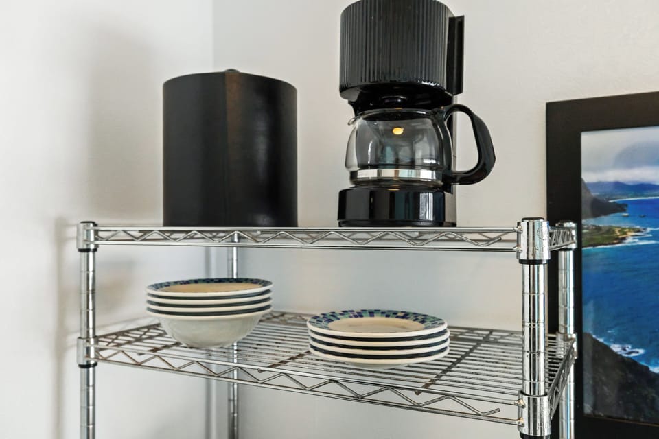 Your morning coffee ritual starts here, with a sleek coffee maker and stylish dishware ready to serve your first cup of the day.