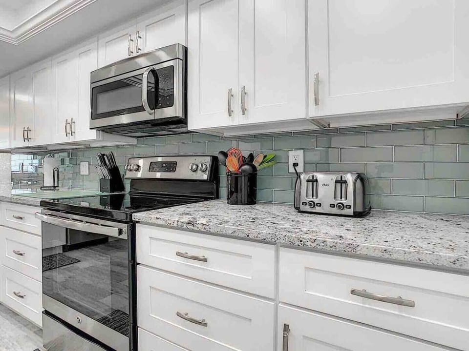 Gorgeous granite countertops and Glass tile backsplash