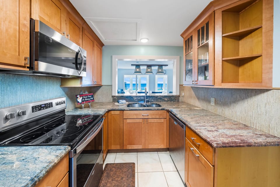 Your fully equipped kitchen features warm wood cabinetry, granite countertops, and modern appliances for all your cooking needs.