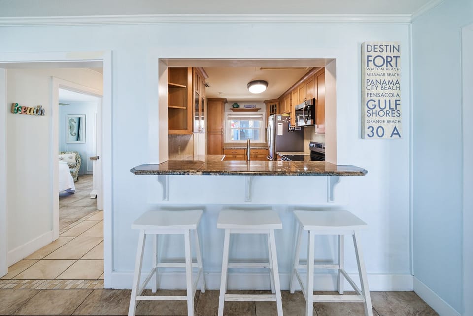 Your beachside kitchen features granite counters and a breakfast bar where you can sip morning coffee while planning your Gulf Coast adventures.
