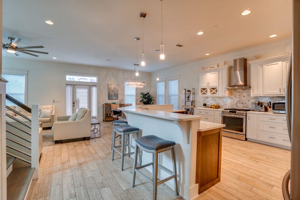 Your open-concept kitchen and living area creates the perfect gathering space with modern appliances, stylish island seating, and warm natural light.
