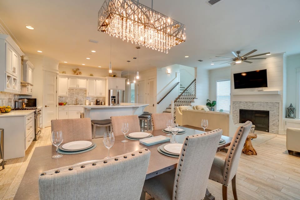 Gather around this elegant dining table while your chef prepares meals in the gleaming kitchen, all under a stunning crystal chandelier.
