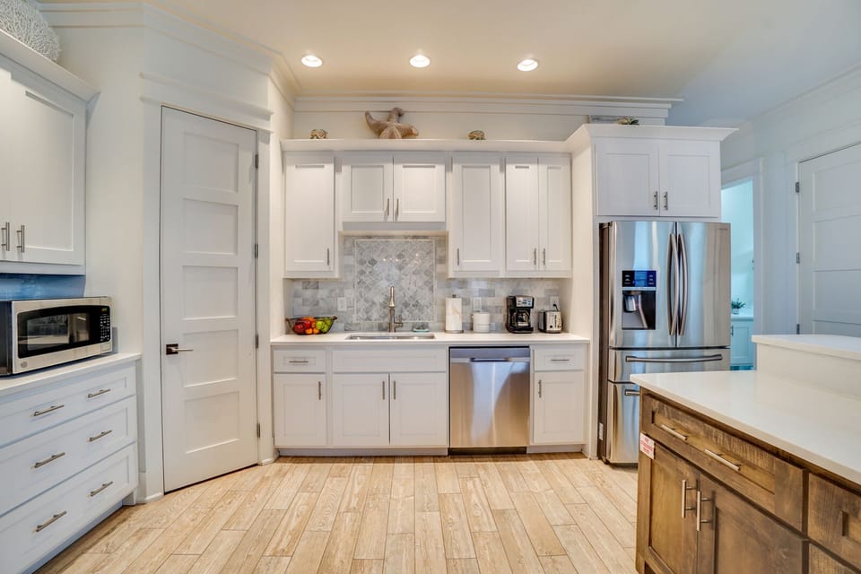 Your gourmet kitchen awaits with gleaming granite counters, stainless appliances, and warm wood floors—perfect for preparing memorable meals.