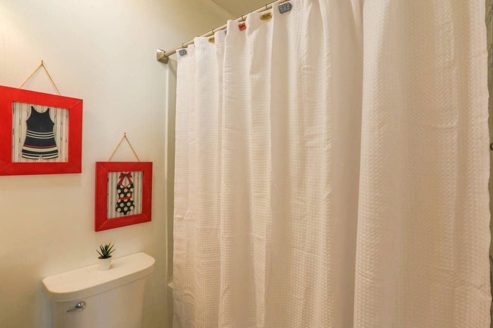 This hallway bathroom has a shower/tub combo.