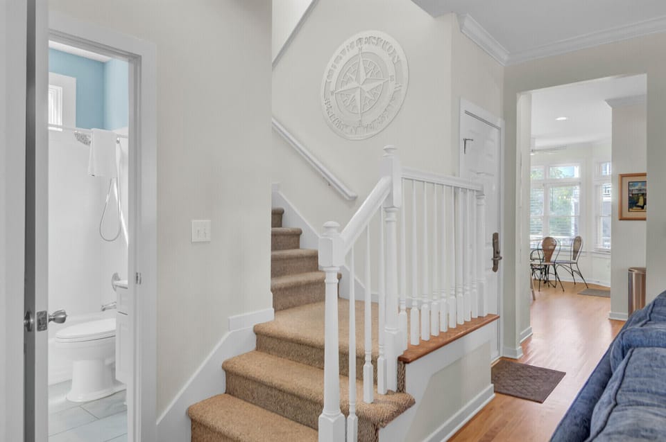 Your elegant staircase leads to upstairs comfort, with a convenient powder room nearby for guests.