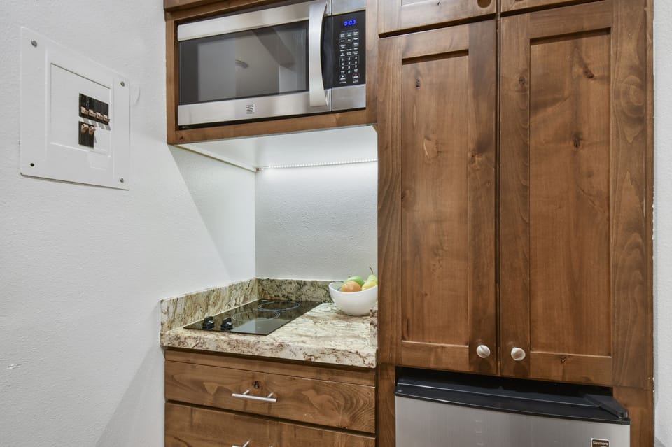 Kitchen includes small fridge, 2 burner cooktop, micro, toaster oven, dishwasher