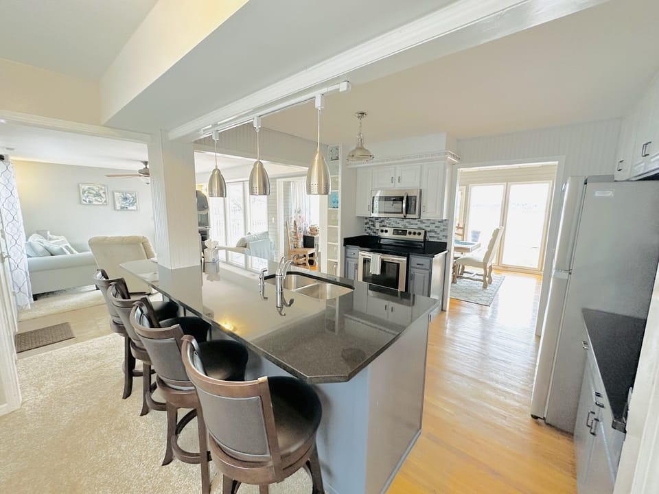Fully stocked kitchen with bar seating.