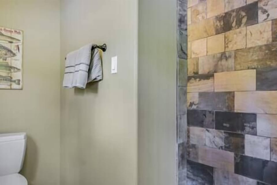 bathroom with walk in stone shower