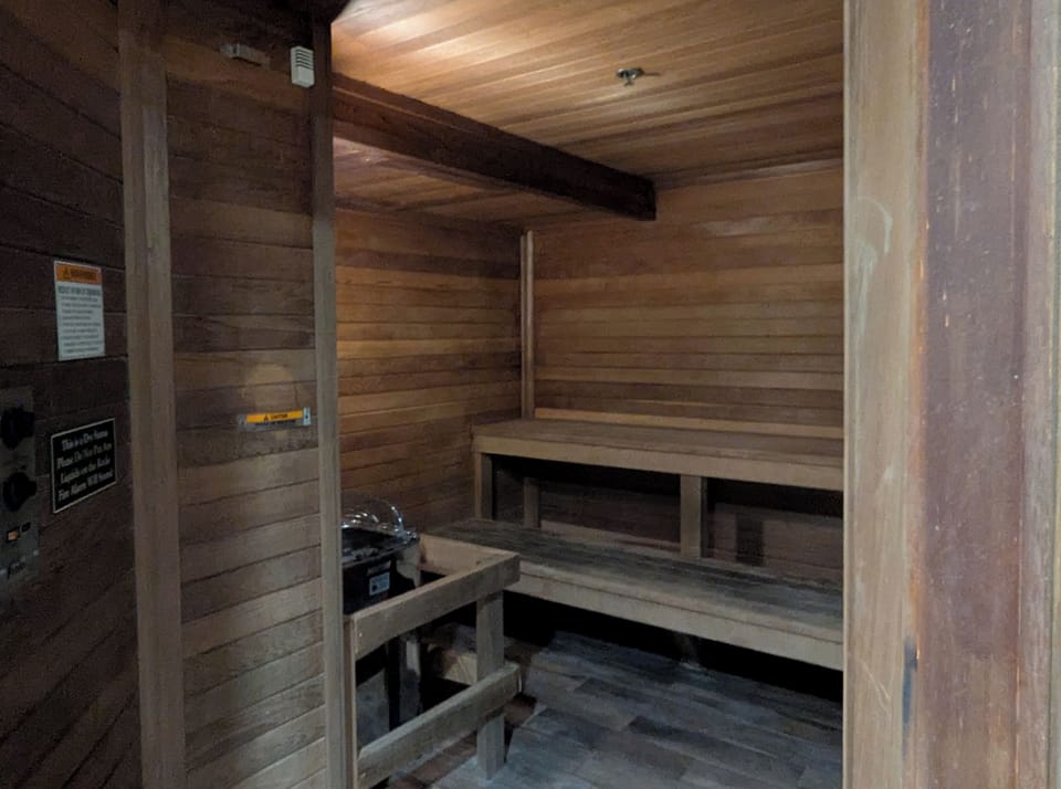 Step into the warmth of your private sauna, where smooth wooden benches and gentle heat melt away the day's stress in complete comfort.