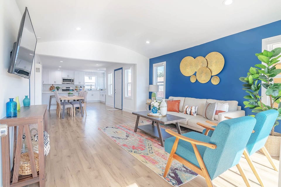 The living room with multiple windows, very bright, natural light.