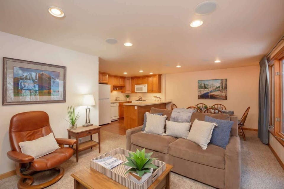 Bright and spacious living room with fireplace and large floor-to-ceiling windows