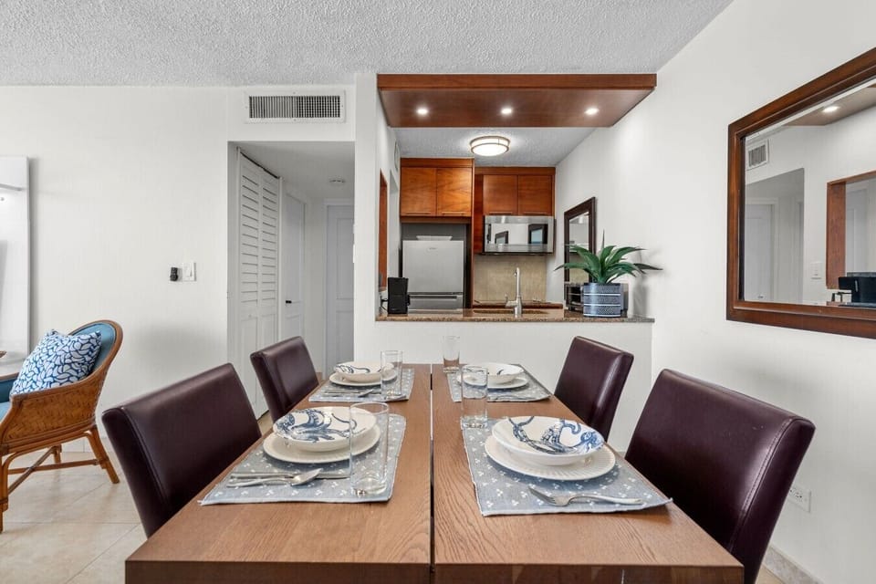 Dining area set for four, ideal for meals after a day at the beach