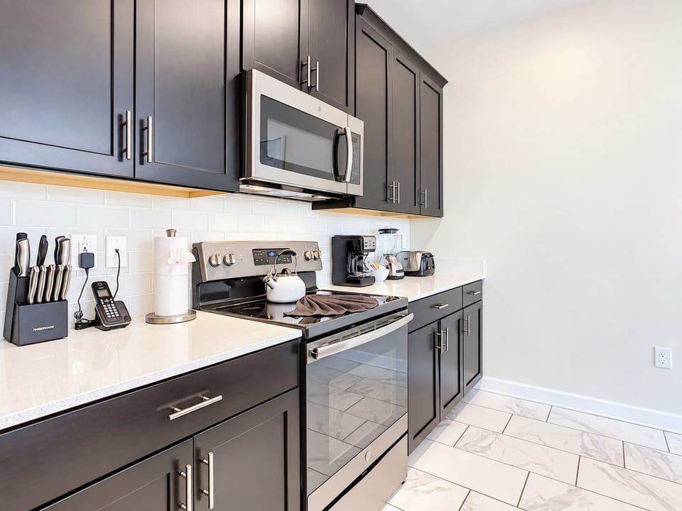 Modern Kitchen with Dark Cabinetry and Stainless Steel Appliances