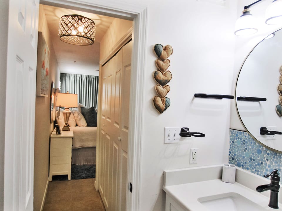 Main bathroom walkway to master bedroom. Luxurious chandelier w/ real crystals
