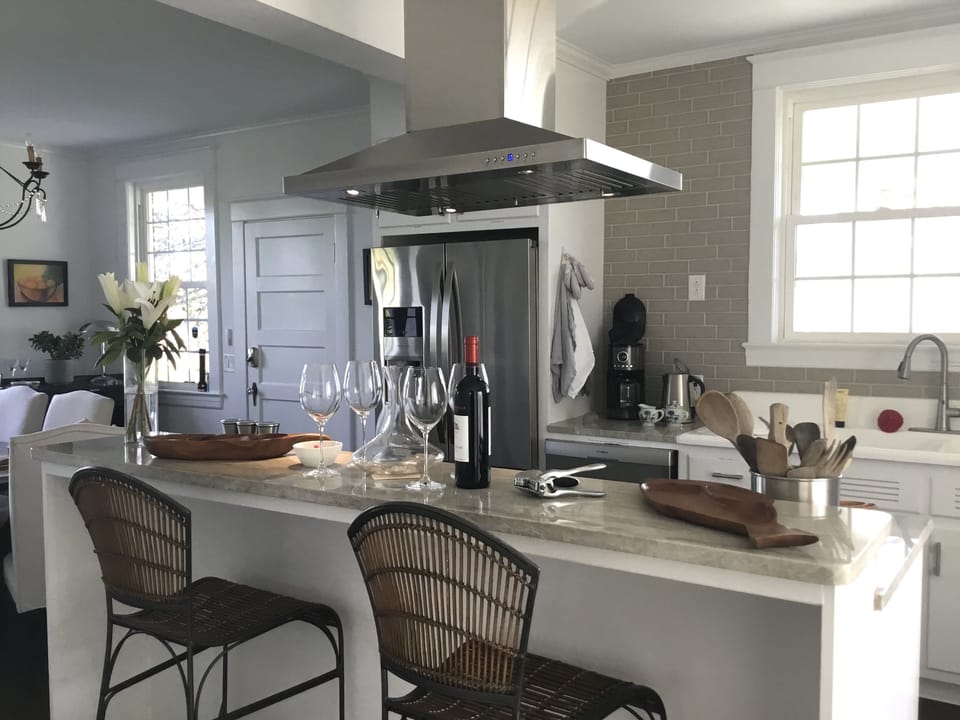 Modern stainless appliances are surrounded by Taj Mahal countertops.