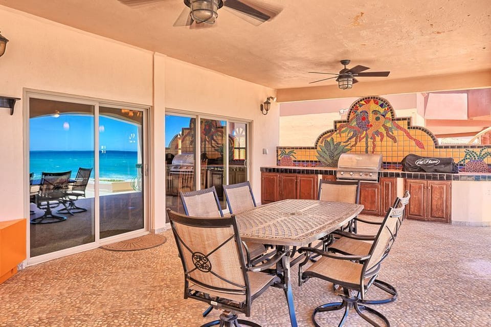 Beachfront porch with BBQ and seating area.