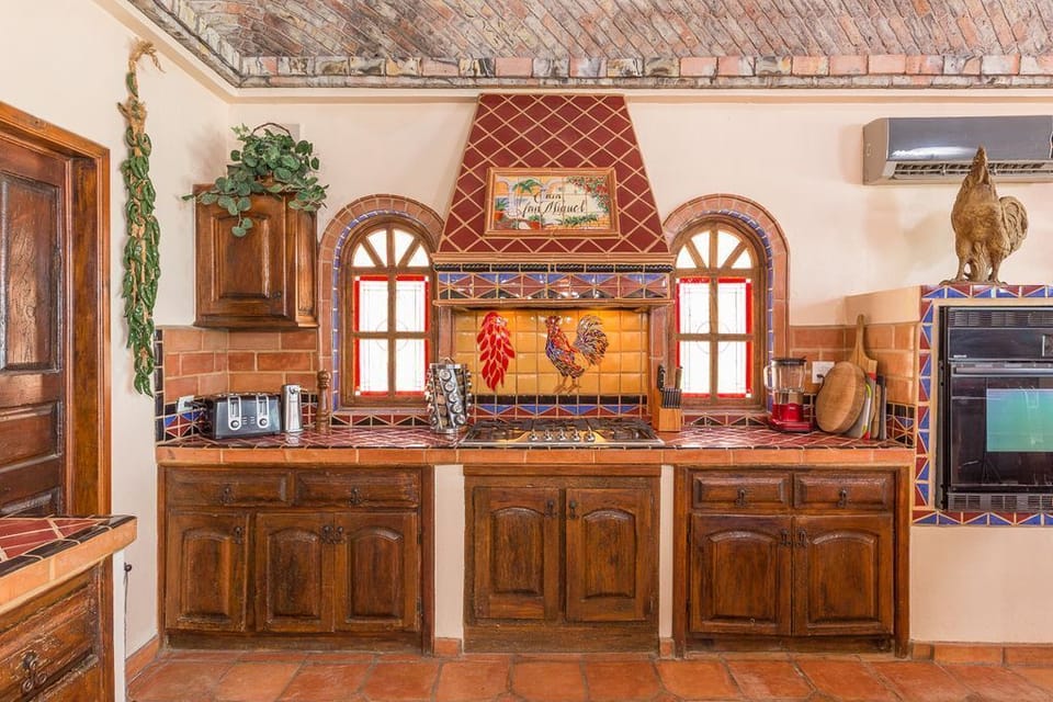 Kitchen with stove top and oven .