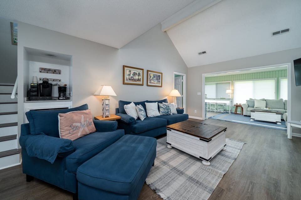 A large great room opens to the glass enclosed sun room