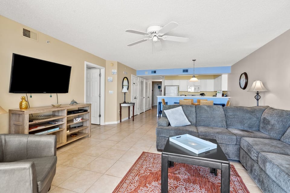 Living area with a sectional, ceiling fan and archway to the kitchen at Sunrise Pointe 6G, Cherry Grove