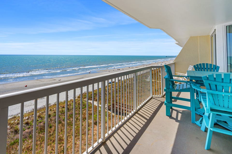 Adirondack chairs on the oceanfront balcony at Sunrise Pointe 6G, a 3-bedroom Cherry Grove vacation rental