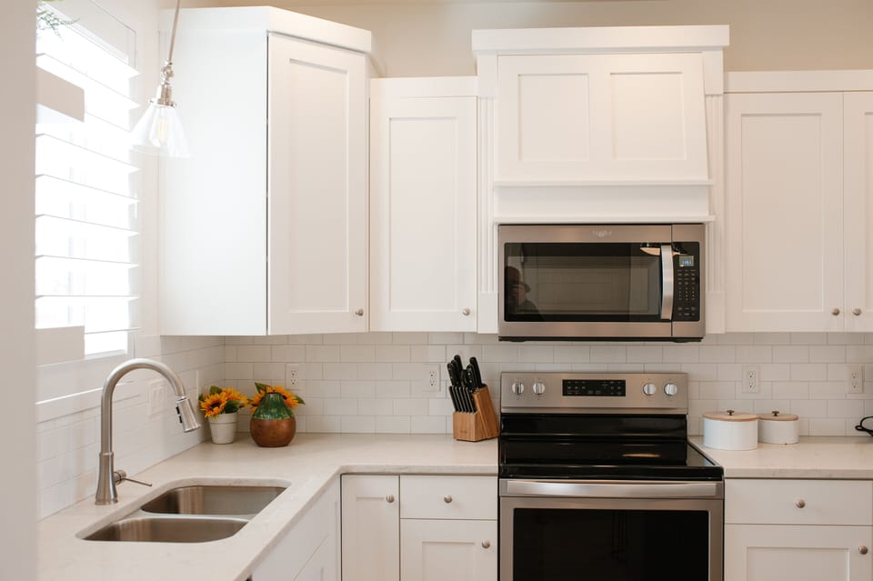 Fully equipped kitchen with stainless appliances and lots of natural light.
